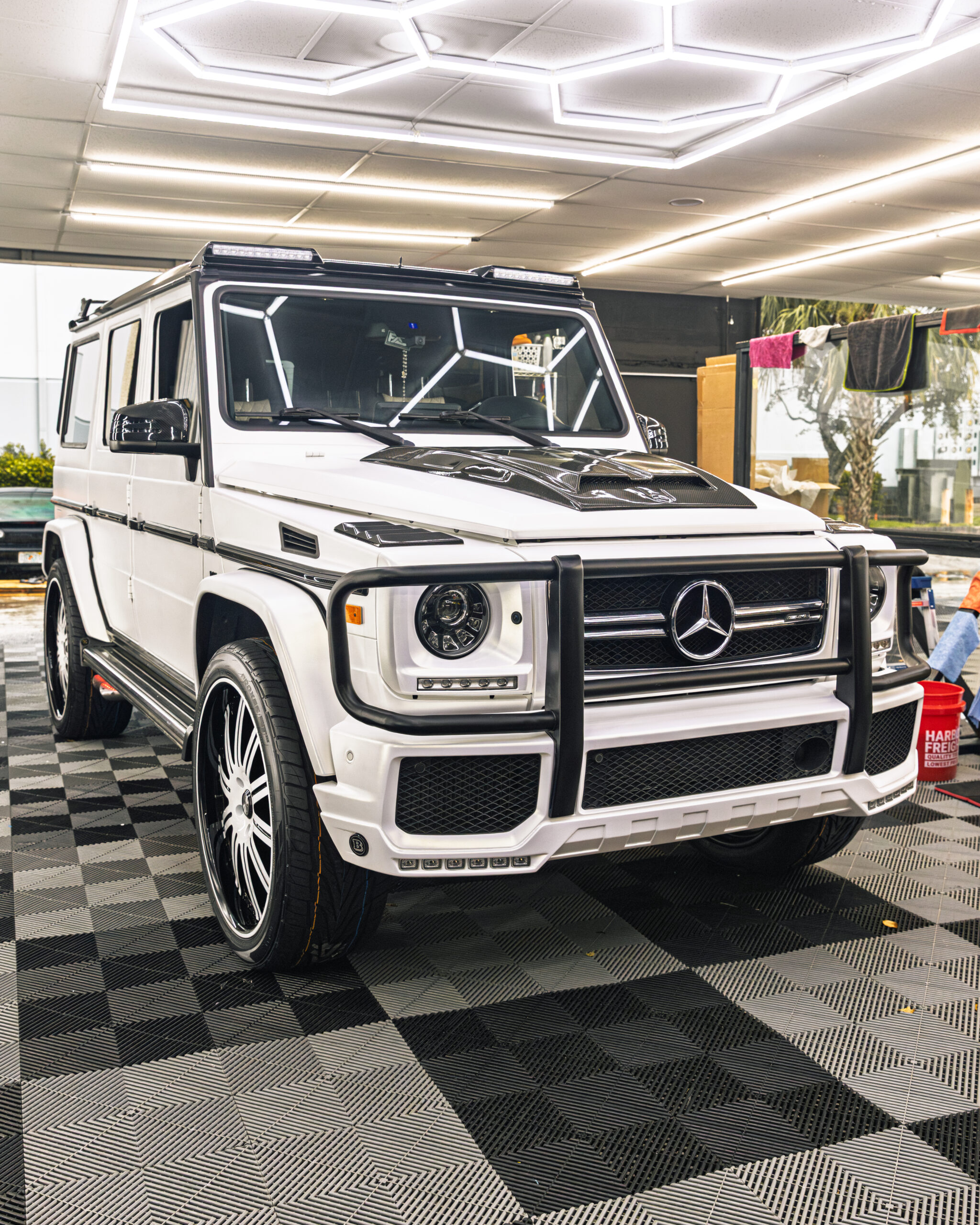 White luxury SUV in professional automotive tint shop